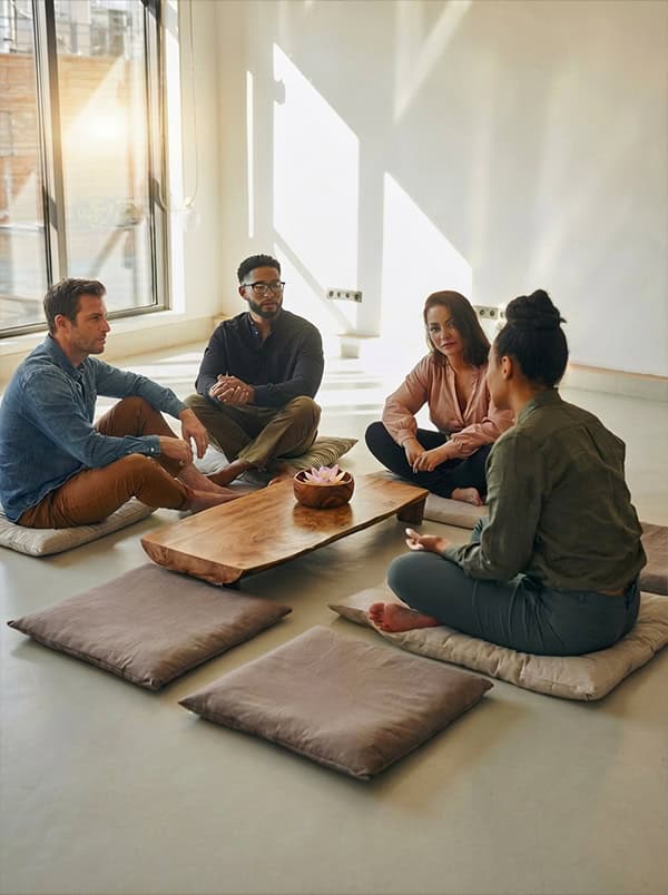 A team sitting together on the floor in an open room